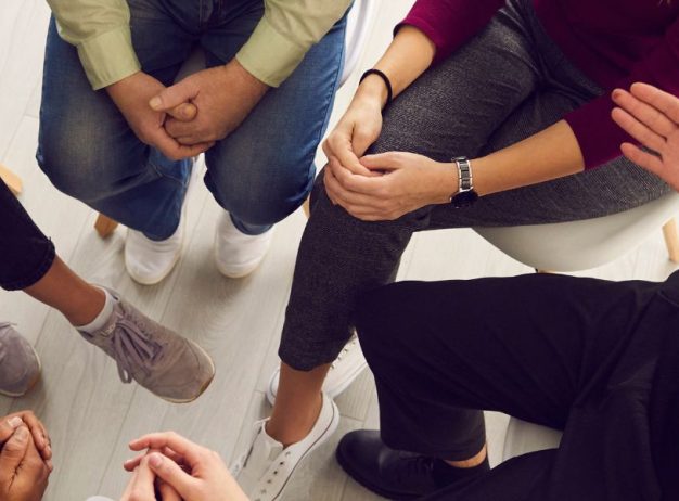 a group of people sitting in a circle