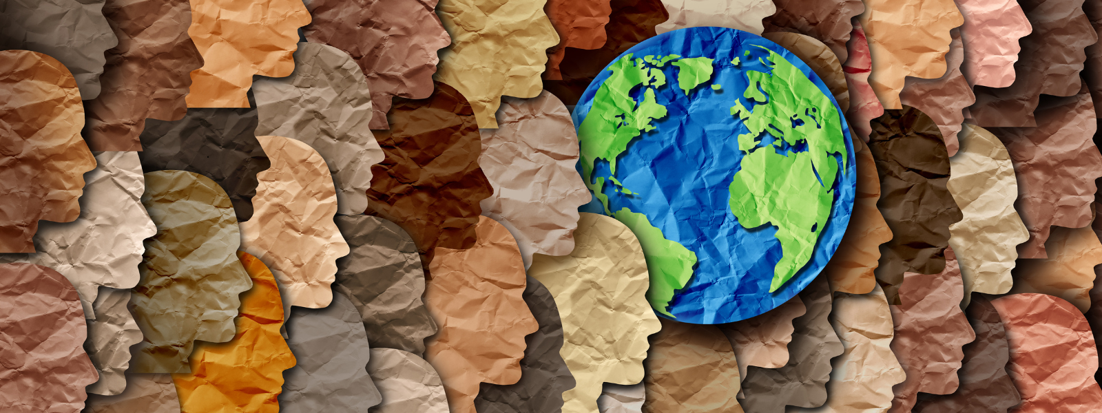 Paper-cut profiles of diverse skin tones form a background, with a globe prominently centered. The image symbolizes global diversity and unity.