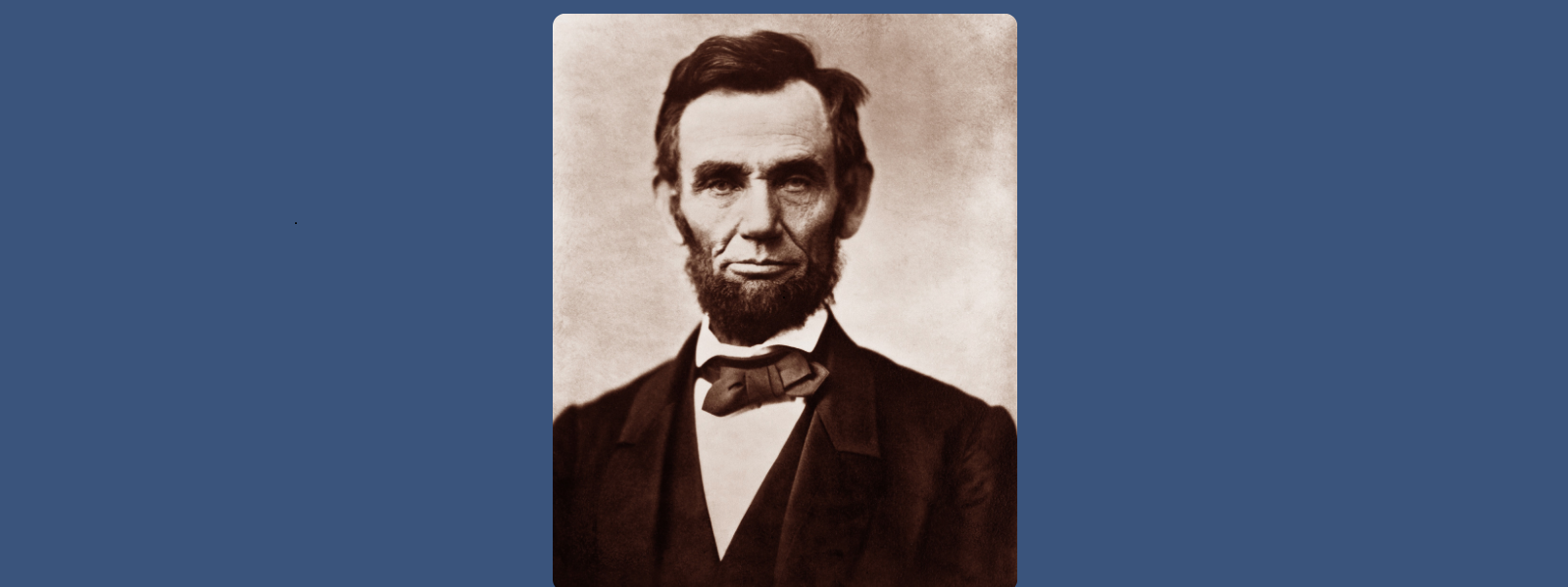 Sepia-toned portrait of a solemn man with a beard and a bow tie, set against a plain background, conveying a historical and dignified tone.